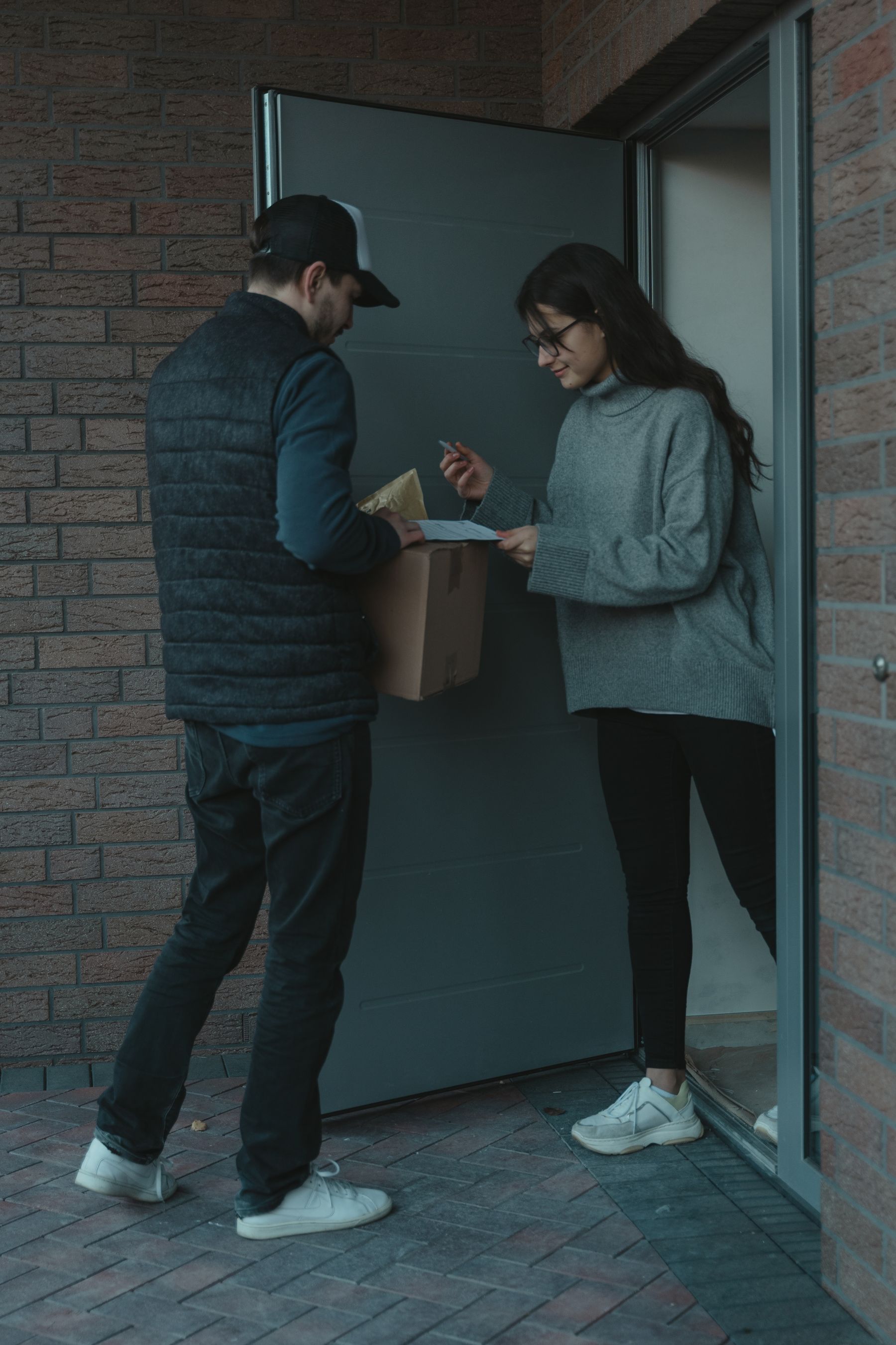 Courier handing a parcel to a business customer